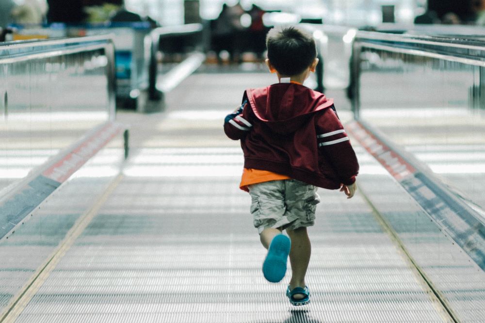 boy running away in airport: single mum holidays