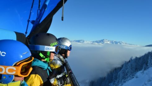 single skier on lift in Kitzbühel Austria on single parent ski holiday