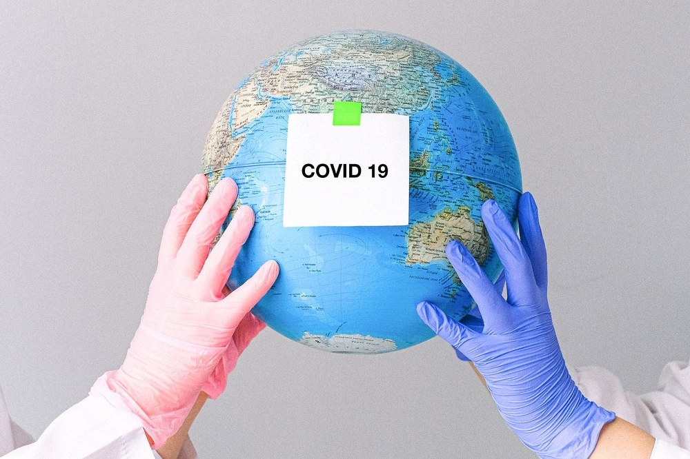 globe with covid 19 sign