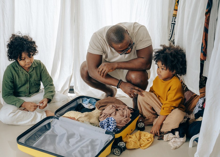 single dad oacking kids suitcase with wheels
