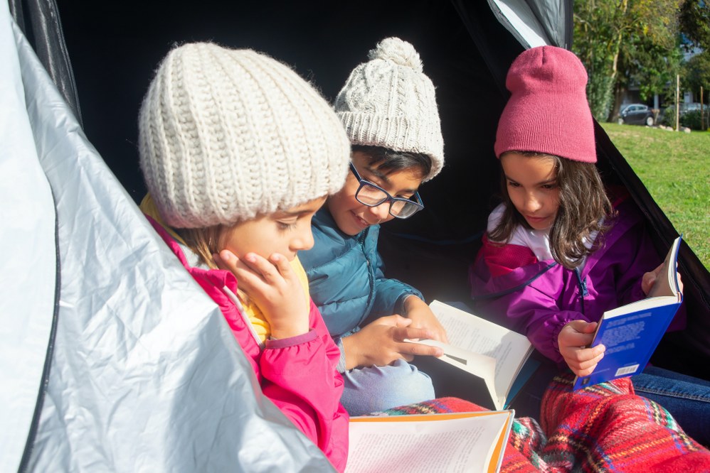 kids wearing hats keeping warm outside tent