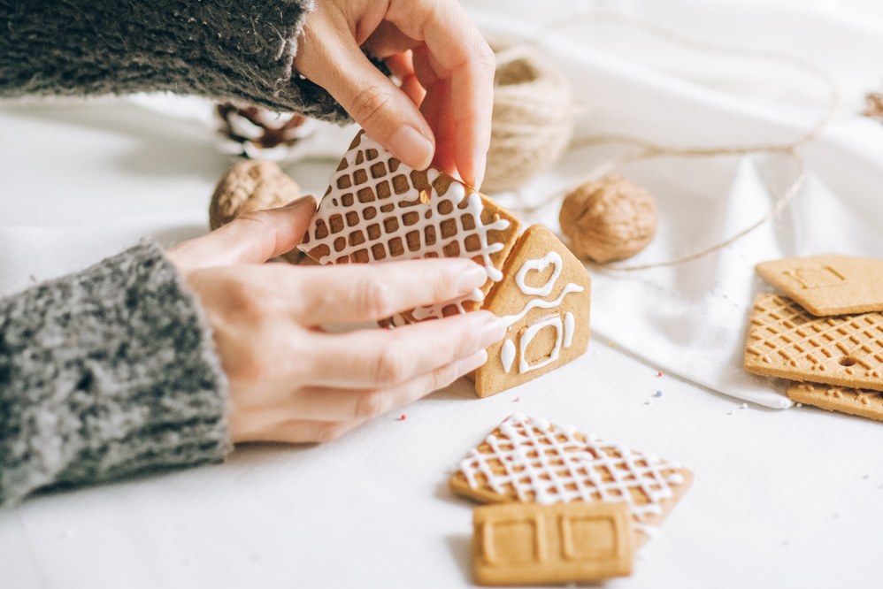 woman making gingerbread house