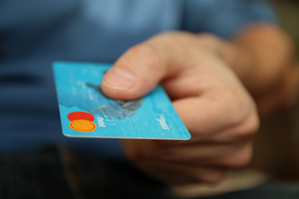 hand with credit card ready to pay