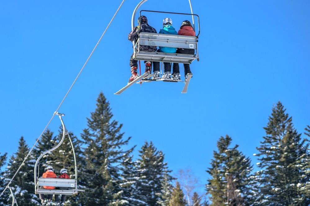 family on chair lift in ski resort