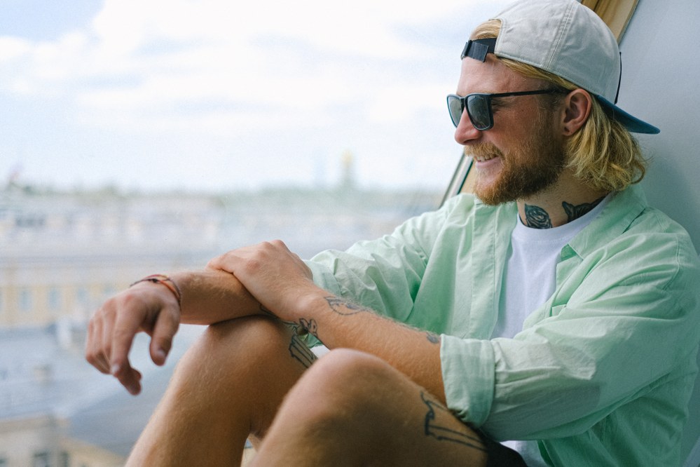 cool looking man in pale green linen shirt on holiday