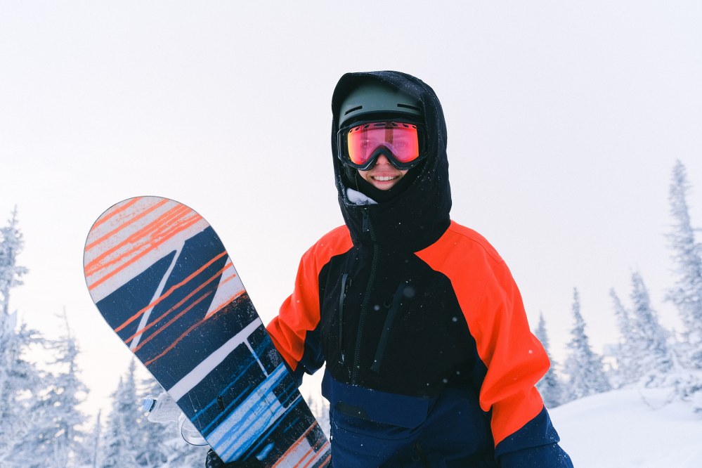 teenager with snowboard on holiday