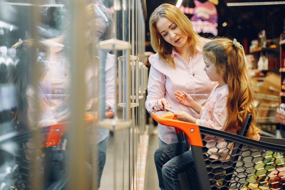 single mum and daughter grocery shopping