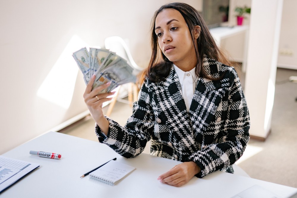 woman looking at money