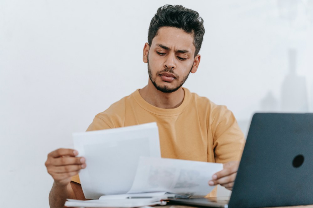 man comparing documents