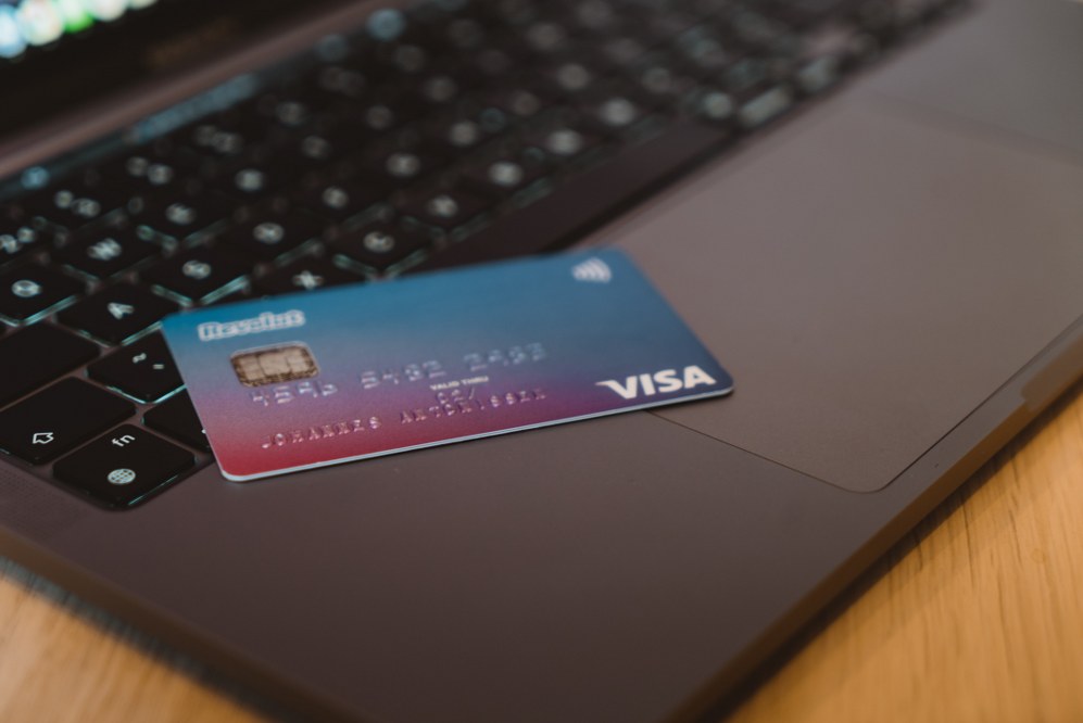 VISA credit card next to laptop