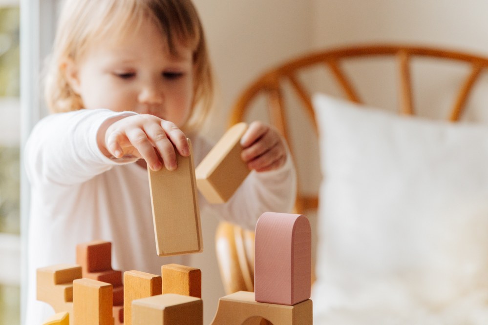 toddler playing with building blocks