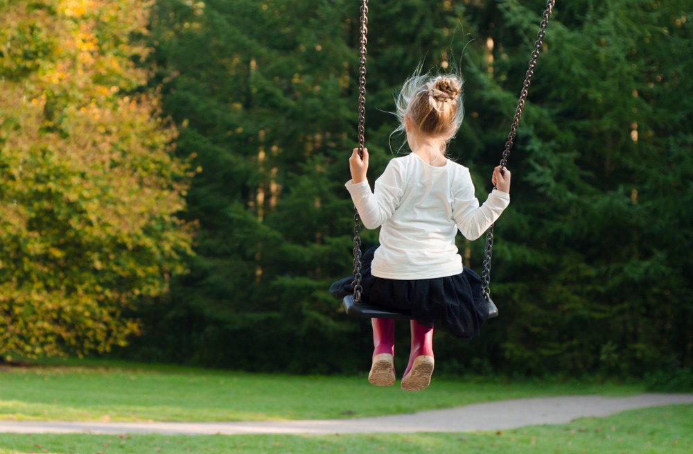 girl on swing in park