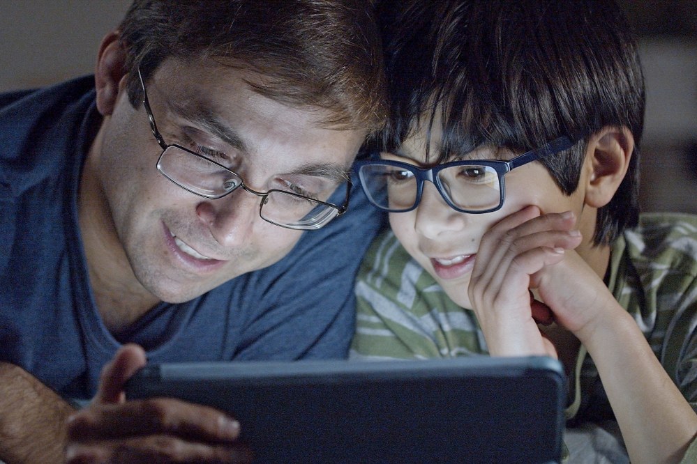 dad and son watching online tutorial together